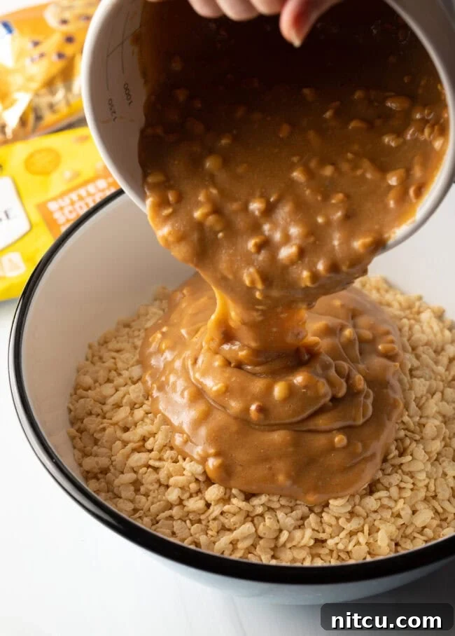 Peanut Butter Rice Krispie Treats 7 Hand pouring butterscotch and peanut butter combination onto a bowl of Rice Krispies cereal.
