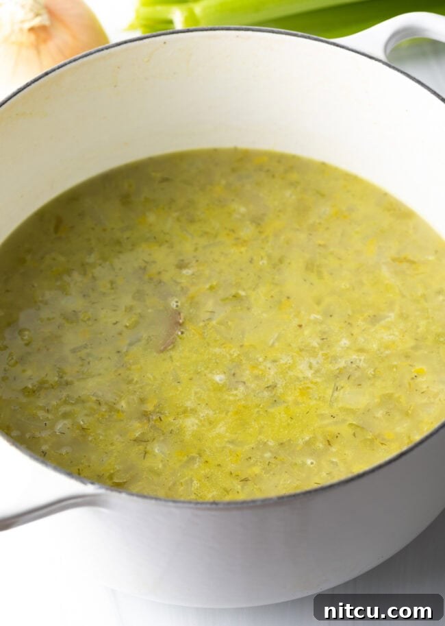 Broth added to chopped celery in a pot.
