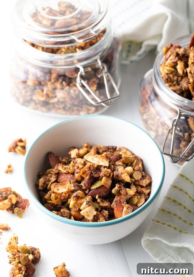Ultimate Keto Granola 14 Top view of a white bowl filled with homemade keto granola, showing its rich texture.
