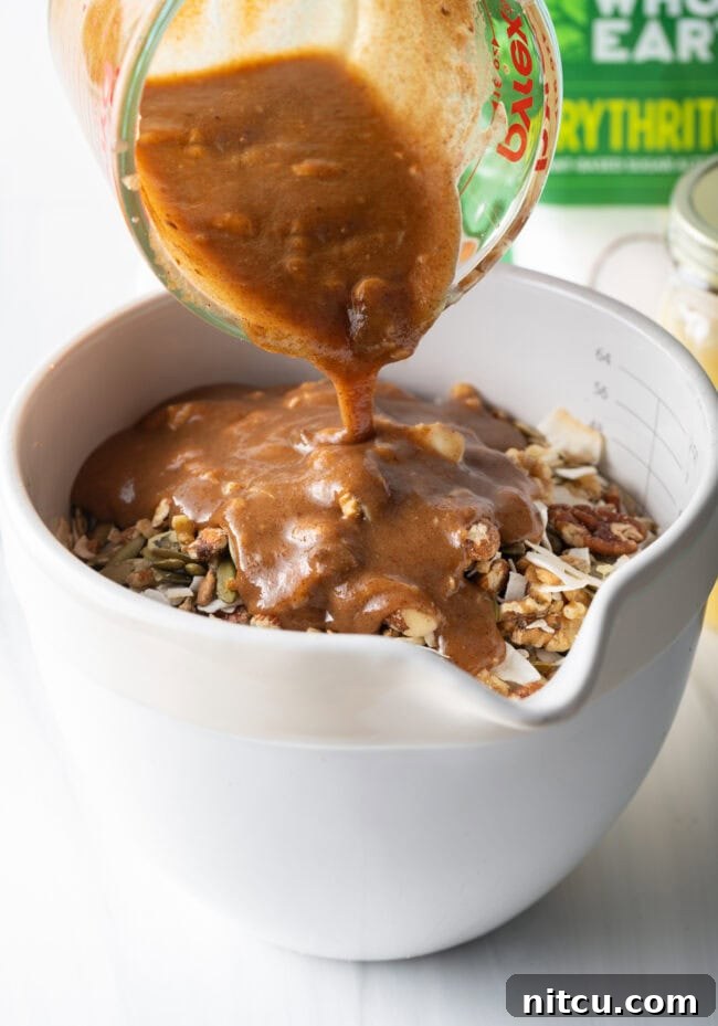 Ultimate Keto Granola 10 Keto granola mixture spread evenly on a baking sheet before baking.