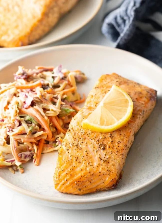 Crispy Skin Air Fryer Frozen Salmon 2 Plate of salmon with coleslaw. Delicious Air Fryer Frozen Salmon Fillet with Skin recipe.