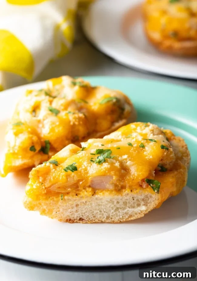 Cajun Shrimp Crostini 2 Close-up view of a Cajun Shrimp Toast recipe, showing toasted baguette topped with creamy, spicy shrimp, melted cheese, and fresh parsley.
