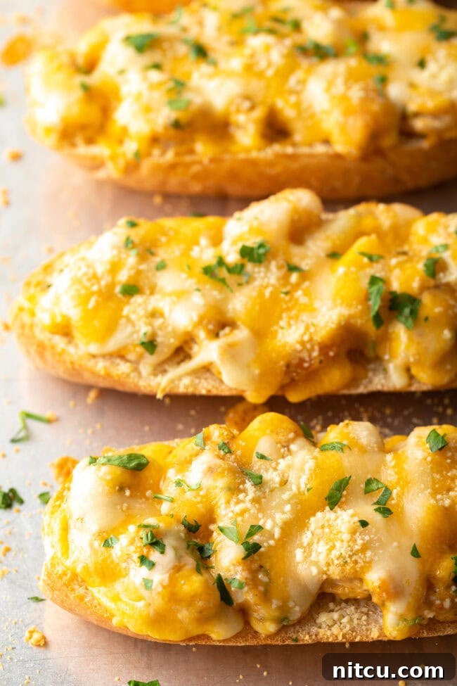 Cajun Shrimp Crostini 10 Freshly baked Salty Dog Cafe-style shrimp toast on a baking sheet, with golden melted cheese and crispy edges.