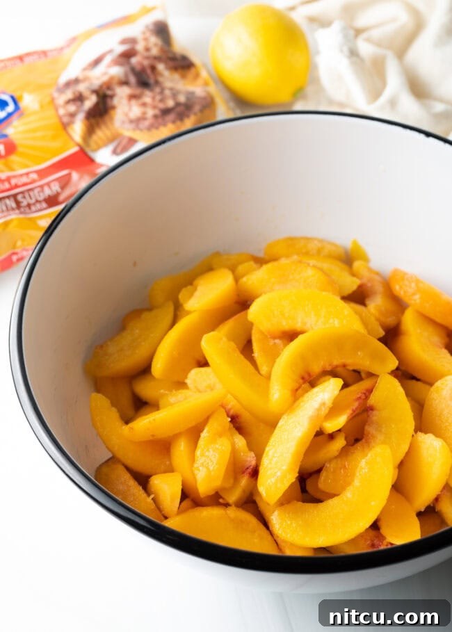 Anytime Peach Pie 6 A bowl filled with freshly sliced peaches, ready for the pie filling.