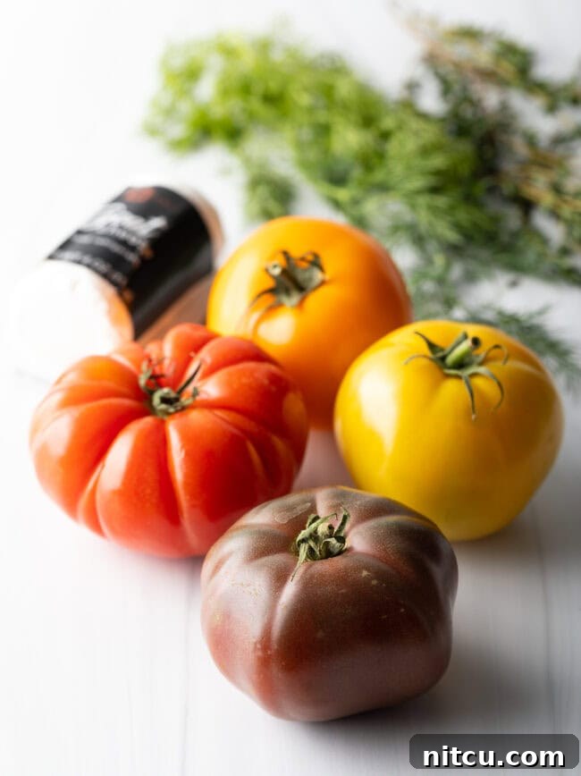 Rustic Italian Tomato Pie 5 Four multicolored heirloom tomatoes displayed, showing their vibrant range of colors.