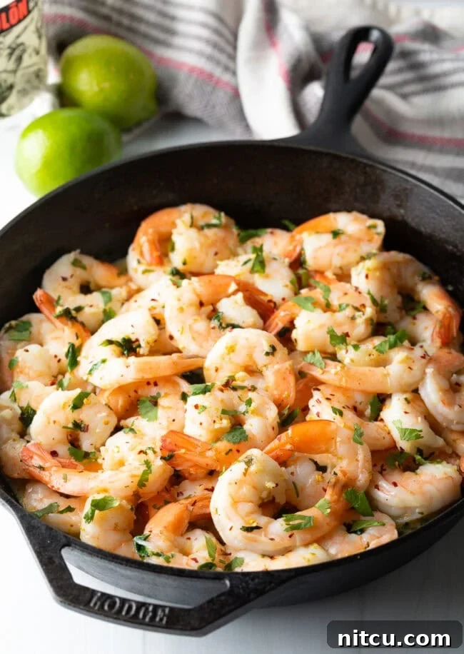 Skillet with sauteed shrimp.