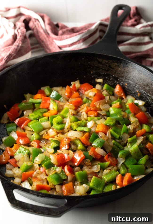 Philly Cheesesteak Bites 7 Skillet with sauteed peppers and onions.