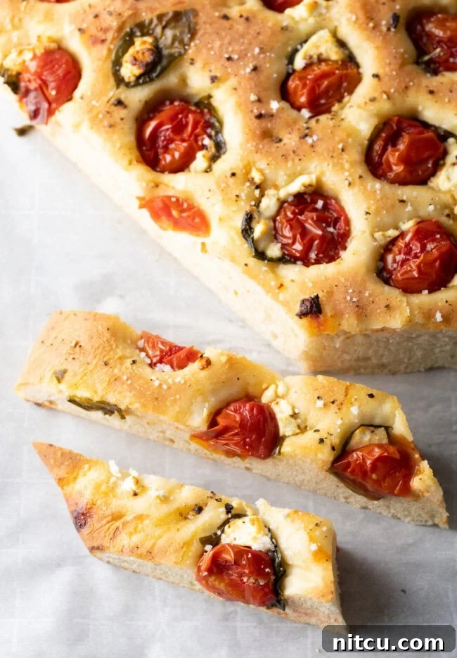 Artisan Tomato Basil Focaccia 11 Top down view large tomato basil focaccia cut into sticks.