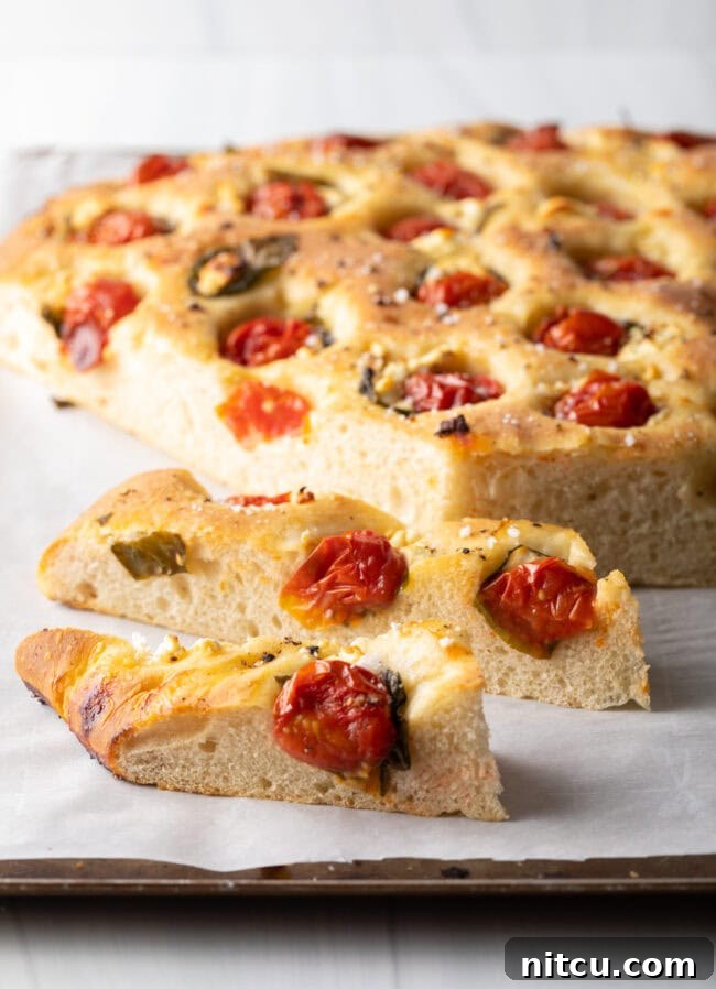 Artisan Tomato Basil Focaccia 4 Tomato bread sliced from a large loaf of focaccia.