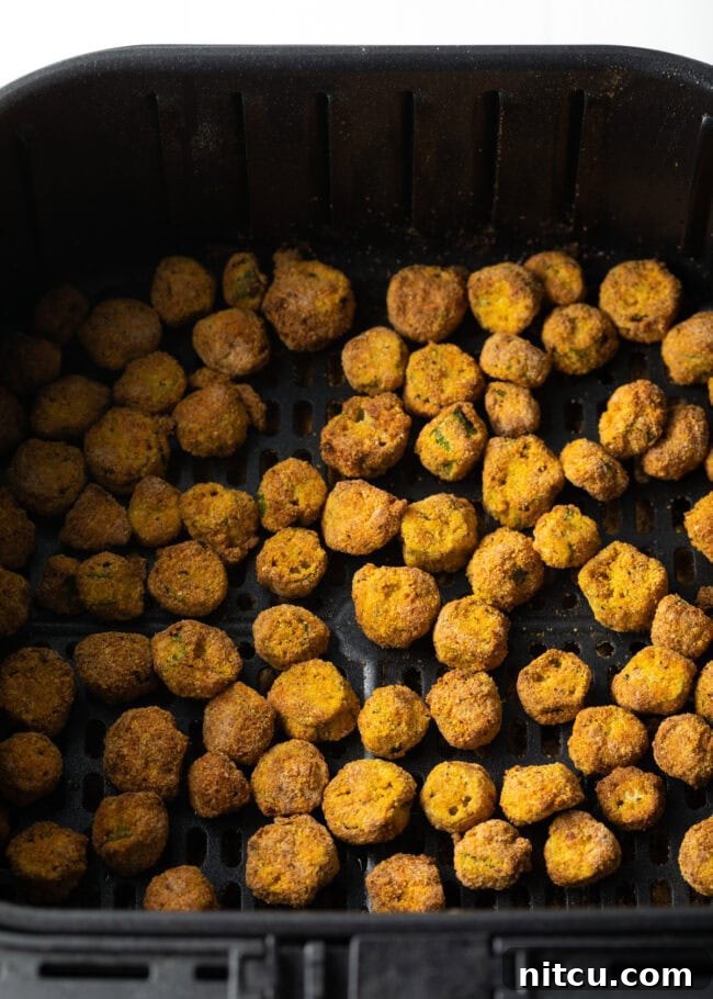 Crispy Air Fryer Okra Fries 11 Top down pieces of fried okra in air fryer basket.