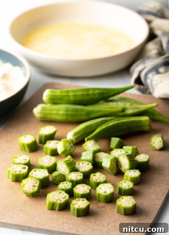 Crispy Air Fryer Okra Fries 7 Chopped fresh okra on a cutting board.