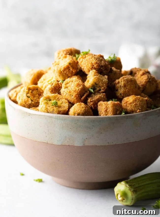 Southern Fried Okra Bliss 2 Bowl overflowing with crunchy breaded fried okra, ready to be served as a classic Southern side dish.