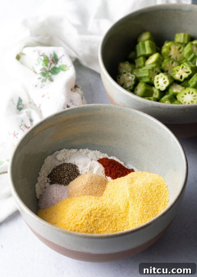 Southern Fried Okra Bliss 5 A bowl containing a mixture of yellow cornmeal, all-purpose flour, and various spices, prepped for breading.