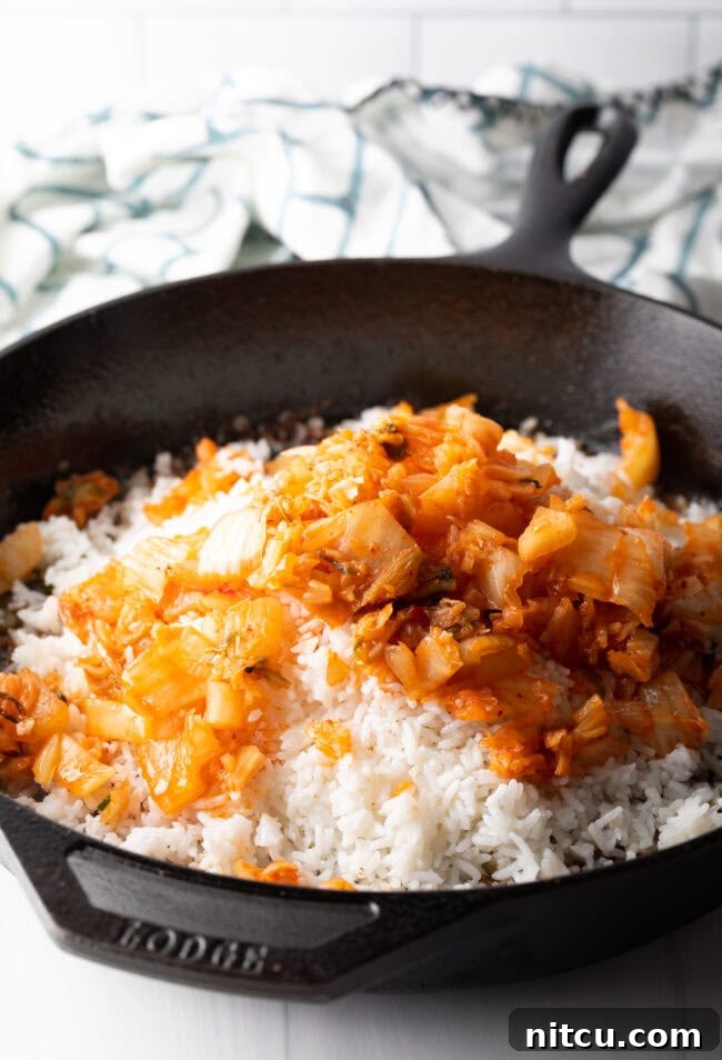 Tropical Kimchi Fried Rice 6 Skillet with rice and chopped kimchi.