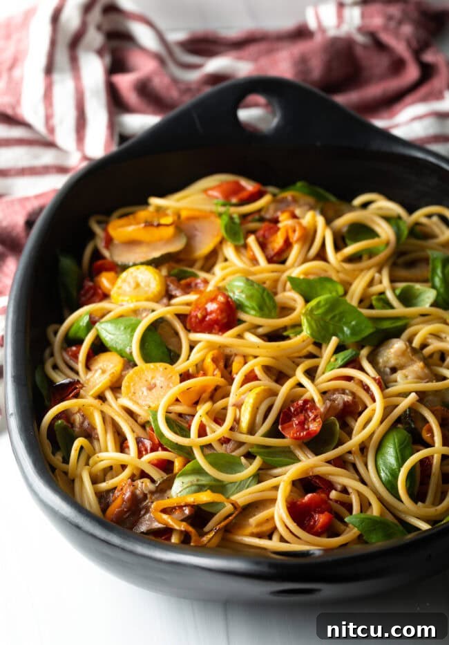 Creamy Burrata and Roasted Summer Harvest Pasta 12 Tossed pasta and vegetables in a large bowl, coated with sauce.