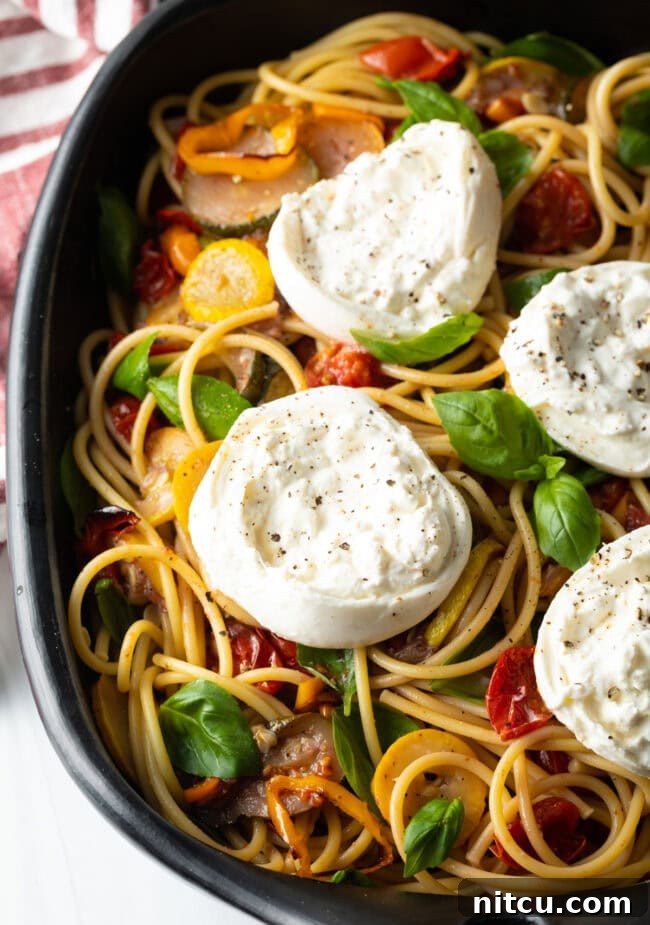 Creamy Burrata and Roasted Summer Harvest Pasta 15 Top down view of a large platter of pasta with burrata and summer roasted vegetables, ready to serve.