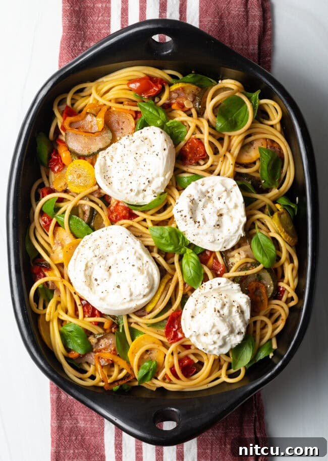 Creamy Burrata and Roasted Summer Harvest Pasta 3 Top down view of pasta burrata with roasted summer vegetables, showcasing the creamy cheese.