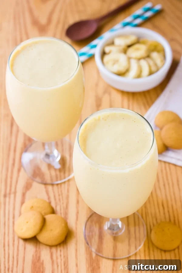 Velvet Banana Pudding Shake 5 A tall glass of Banana Pudding Milkshake garnished with whipped cream and cookies
