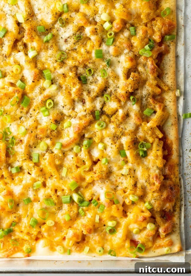 Cheesy Mac Pizza 2 Top down macaroni and cheese pizza with fresh scallions.