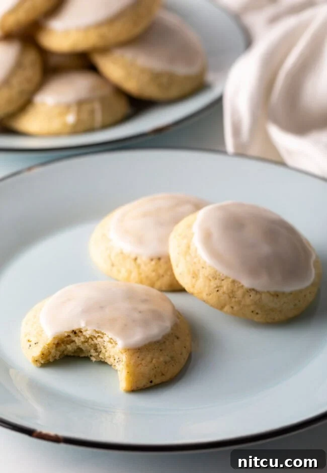 Bergamot Bliss Bites 13 Three perfectly baked Earl Grey cookies, or tea cakes, on a plate, one with a bite taken out.