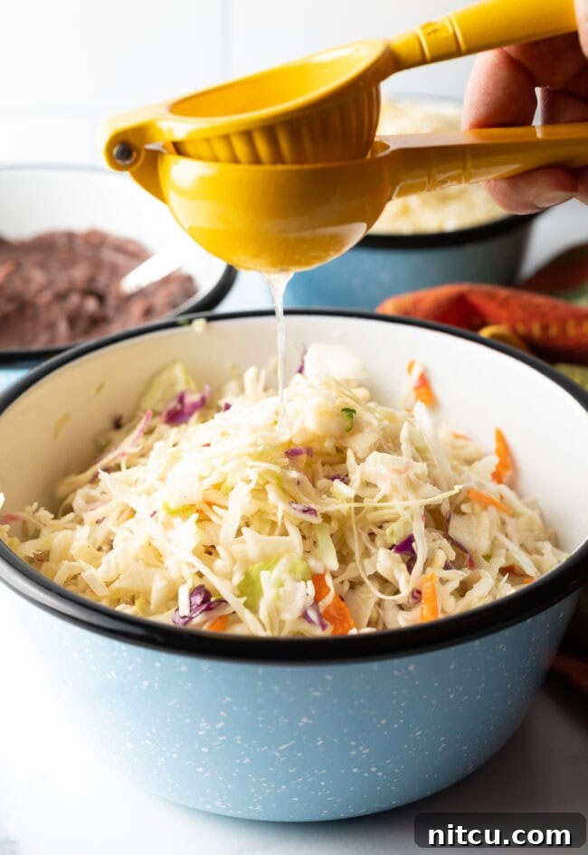 Homemade Pupusas 5 Squeezing a lime into a bowl of shredded cabbage and carrots for curtido.