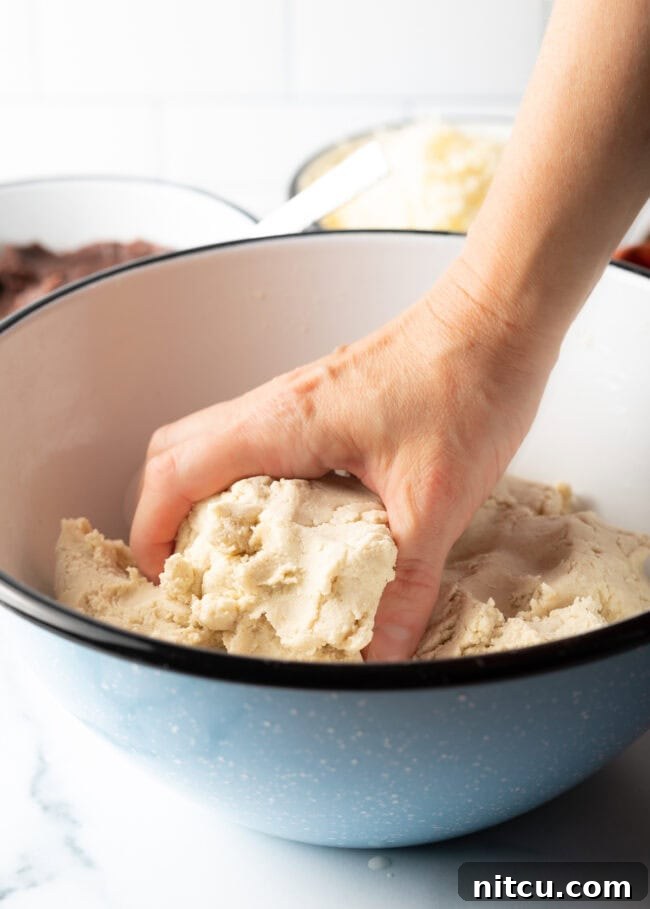 Homemade Pupusas 7 Hands shaping masa harina and water into a soft, smooth dough.