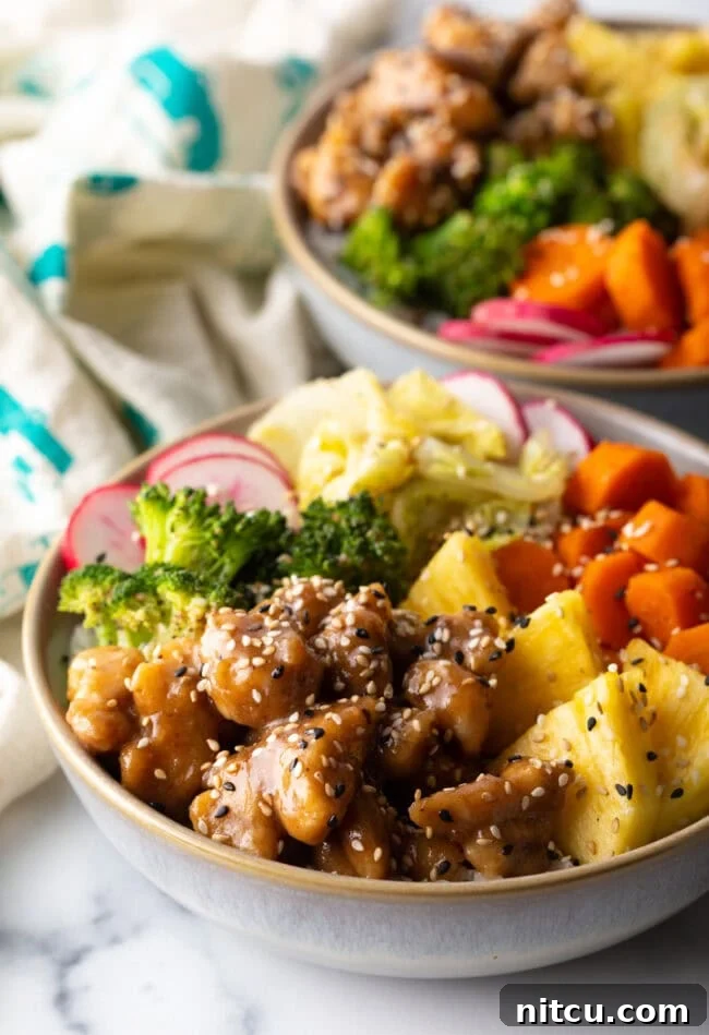 Simply Delicious Chicken Teriyaki Bowl 2 Chicken teriyaki bowl with pineapple, carrots, broccoli, cabbage, and radishes.