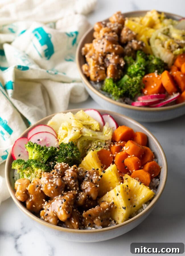 Simply Delicious Chicken Teriyaki Bowl 11 Two bowls with chicken teriyaki, cooked veggies, and fresh toppings.