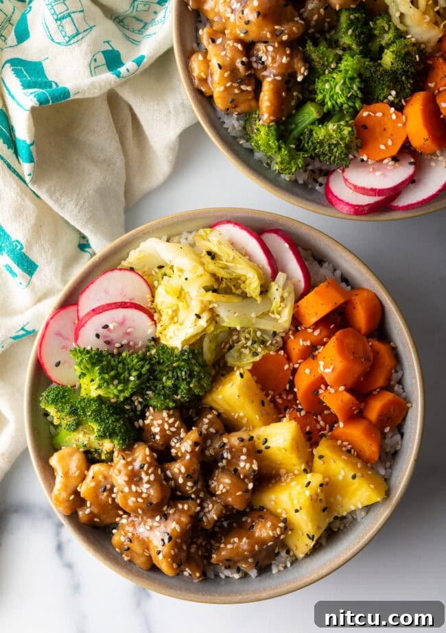 Simply Delicious Chicken Teriyaki Bowl 3 Top down view two bowls loaded with teriyaki chicken, rice, and veggies.