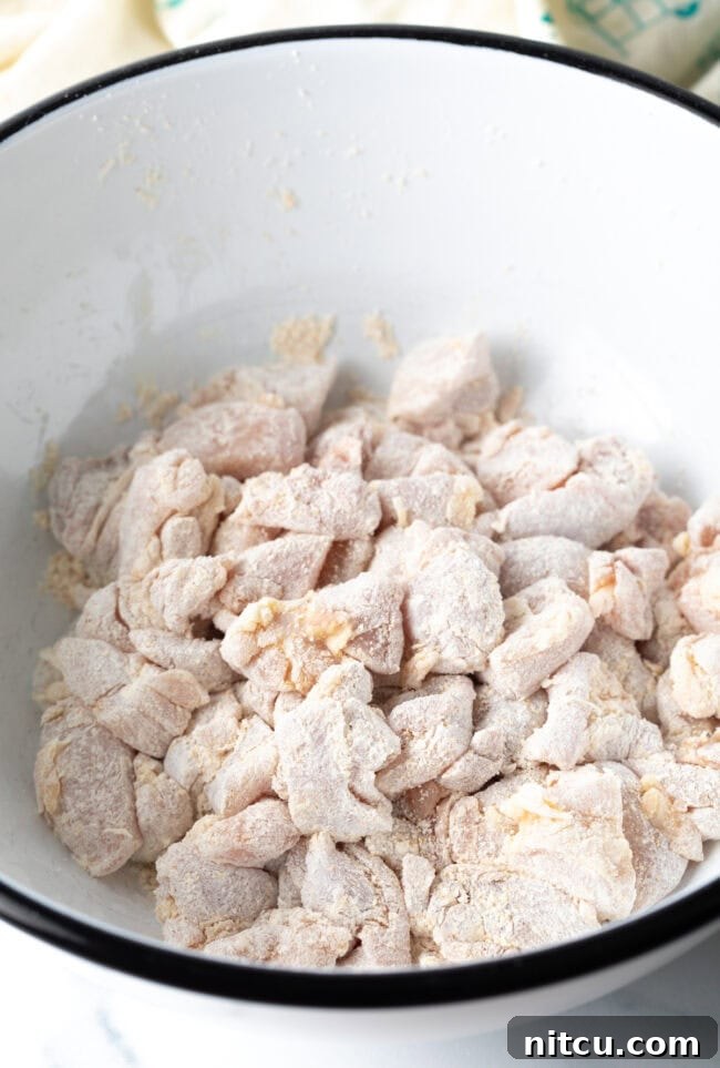 Simply Delicious Chicken Teriyaki Bowl 6 Pieces of chicken tossed with cornstarch in a bowl.