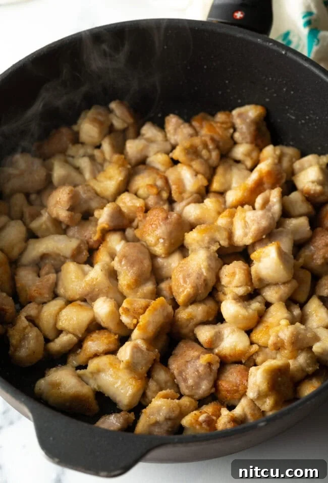 Simply Delicious Chicken Teriyaki Bowl 8 Sauteed cornstarch breaded chicken pieces in a skillet.