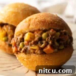 A close-up of a golden South African Fat Cake (Vetkoek).