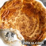 A delectable baked rice pudding slice, showcasing its golden crust and creamy interior.