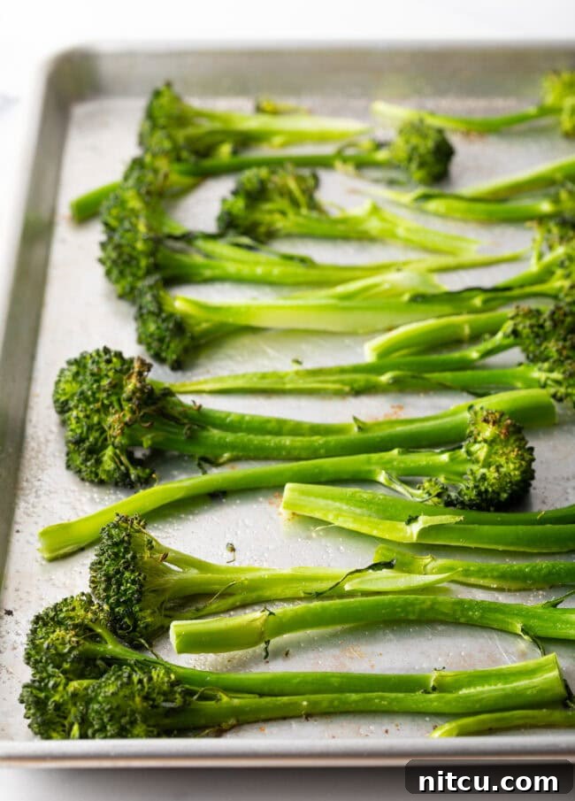 Roasted Broccolini with Chili Honey Glaze 5 Roasted baby broccoli on a baking sheet.
