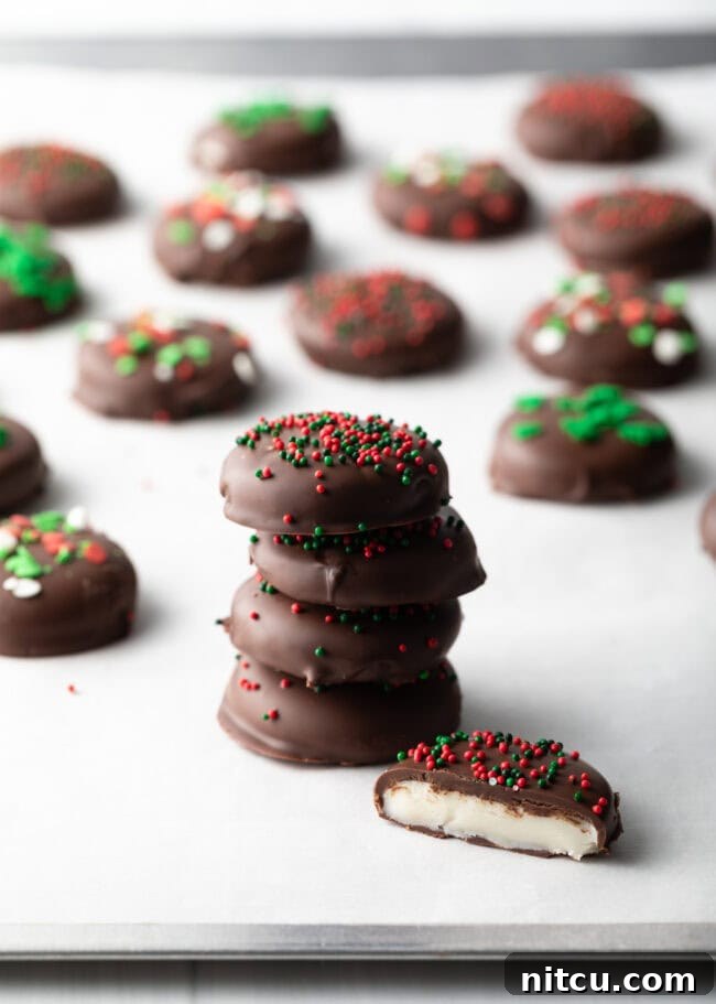 Refreshing Homemade Peppermint Delights 12 Four peppermint patty candies stacked on top of each other, fifth piece with bite taken out. Rows of more candies in the background.
