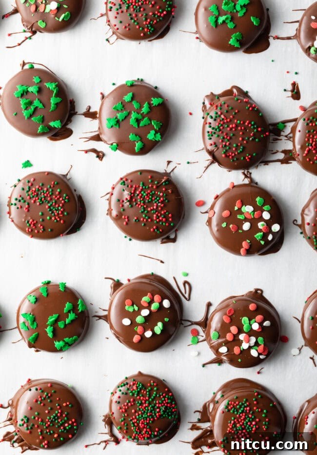Refreshing Homemade Peppermint Delights 10 Dipped peppermint patties on parchment paper, sprinkled with green and red candies.