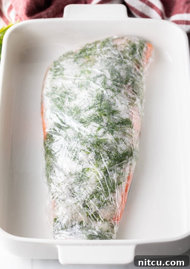 Homemade Gravlax Cured Salmon 8 Salmon fillet wrapped tightly in plastic wrap, ready for pressing.