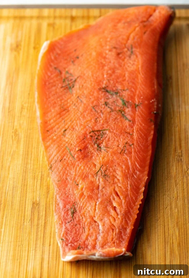 Homemade Gravlax Cured Salmon 10 Unwrapped and rinsed salmon fillet on a cutting board, perfectly cured and ready for slicing.