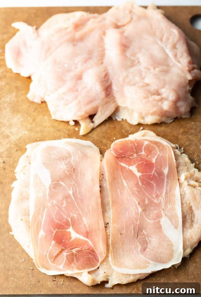 Savory Stuffed Chicken Rolls 6 Butterflied chicken with slices of prosciutto on each half, ready for filling.