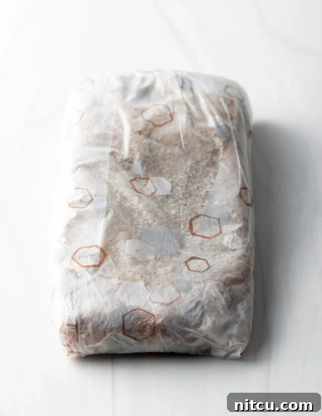 Perfect Homemade Beef Bacon 6 Salted meat wrapped tightly in plastic wrap.