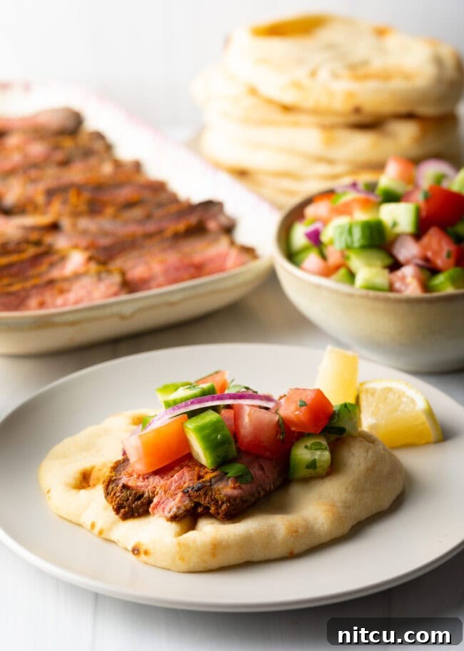 Authentic Street Style Beef Shawarma 12 Beef shawarma recipe on naan, topped with chopped cucumbers and tomatoes.