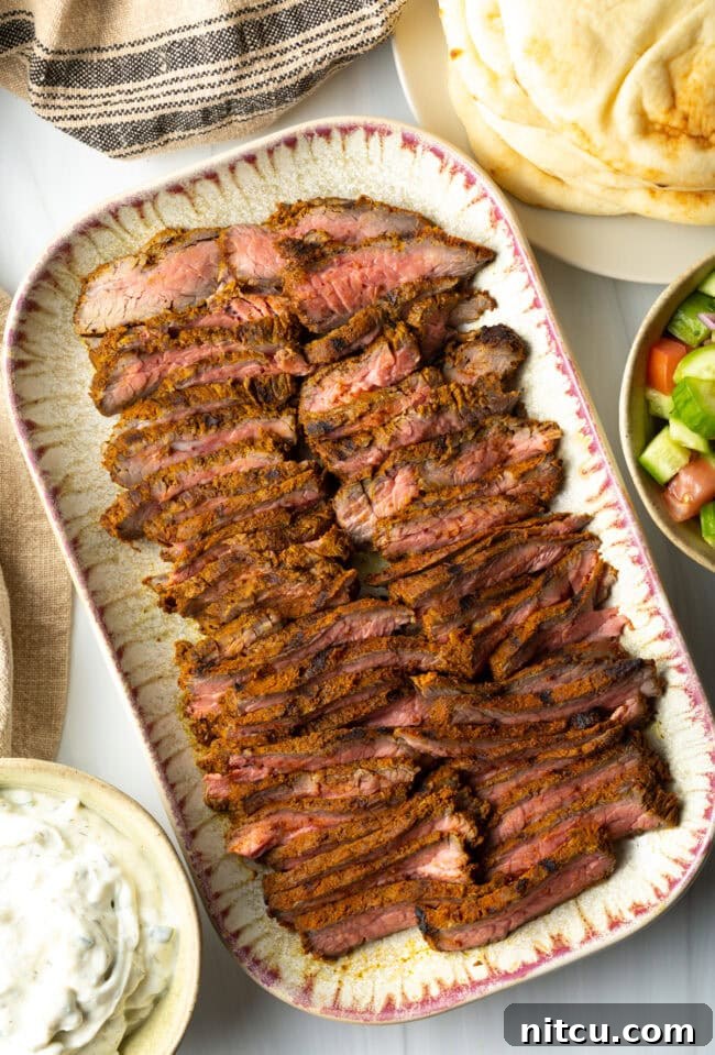 Authentic Street Style Beef Shawarma 3 Top down slices of beef shawarma on a serving platter.