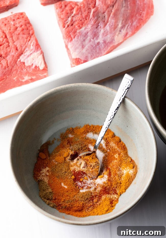 Authentic Street Style Beef Shawarma 7 Bowl with blend of spices and metal spoon.