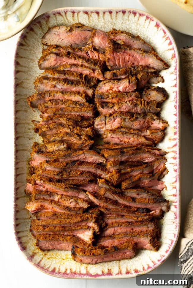 Authentic Street Style Beef Shawarma 10 Top down slices of beef on a serving platter for shawarma or gyro.