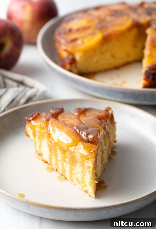 Effortless Apple Caramel Flip Cake 4 Slice of apple upside down cake on a white plate.