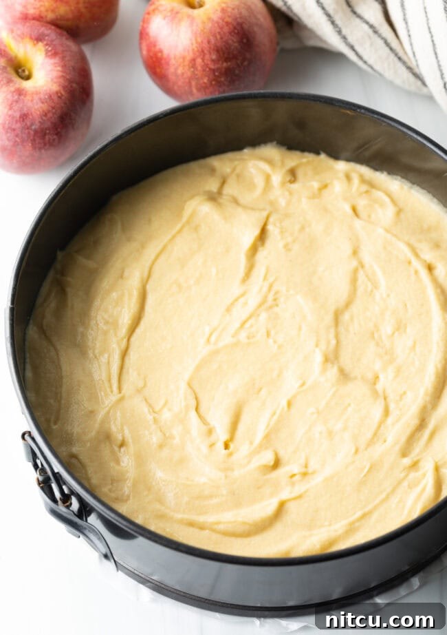 Effortless Apple Caramel Flip Cake 6 Cake batter spread in a springform baking pan.