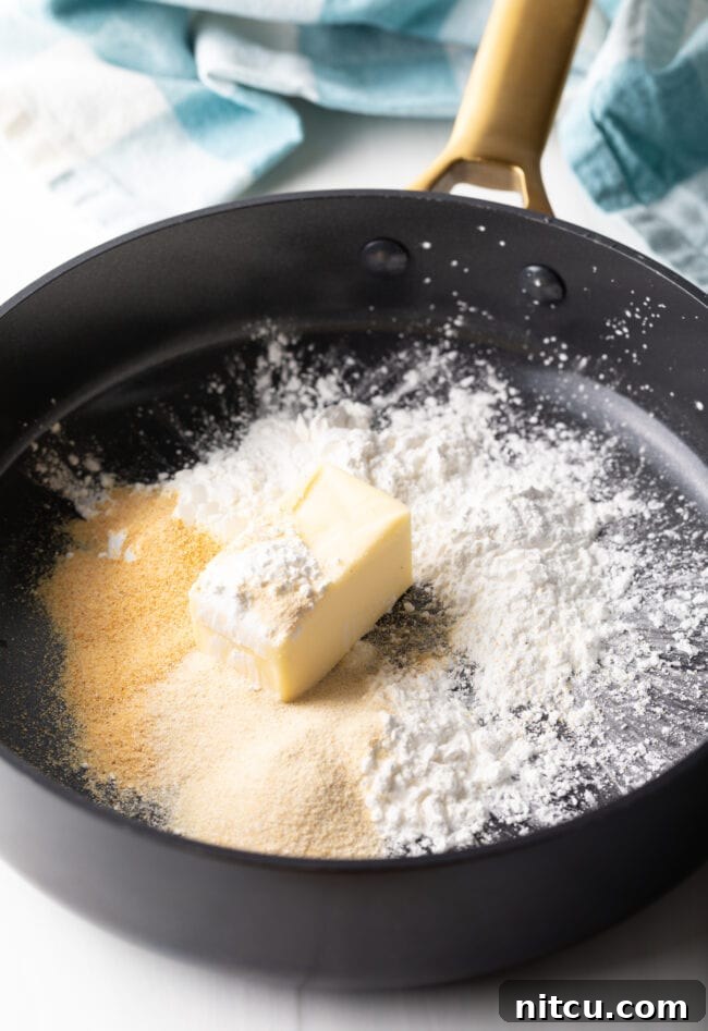 Butter and cornstarch mixed into a paste in a deep skillet over medium heat.