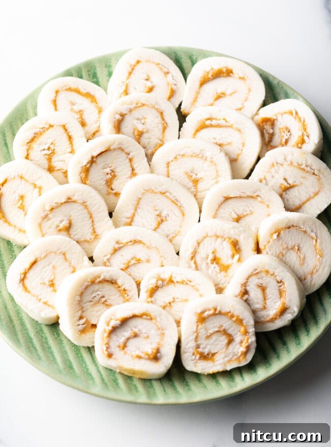 Spudnut Delights 13 Green plate filled with round peanut butter potato candy slices.