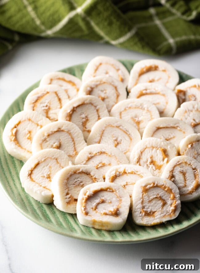 Spudnut Delights 14 Green plate filled with round potato peanut butter candy slices.