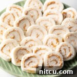 Spudnut Delights 15 Green plate filled with round peanut butter potato candy slices.